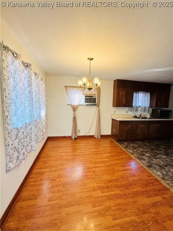 8612 Maryland Ave, Marmet, WV 25315 - unfurnished dining area with light wood finished floors and a chandelier