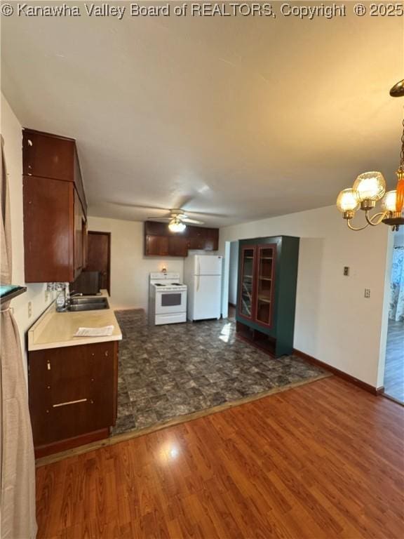 8612 Maryland Ave, Marmet, WV 25315 - kitchen featuring white appliances, dark wood-type flooring, a chandelier, a ceiling fan, and light countertops