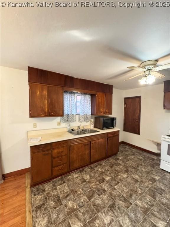 8612 Maryland Ave, Marmet, WV 25315 - kitchen with black microwave, white range oven, light countertops, and a ceiling fan