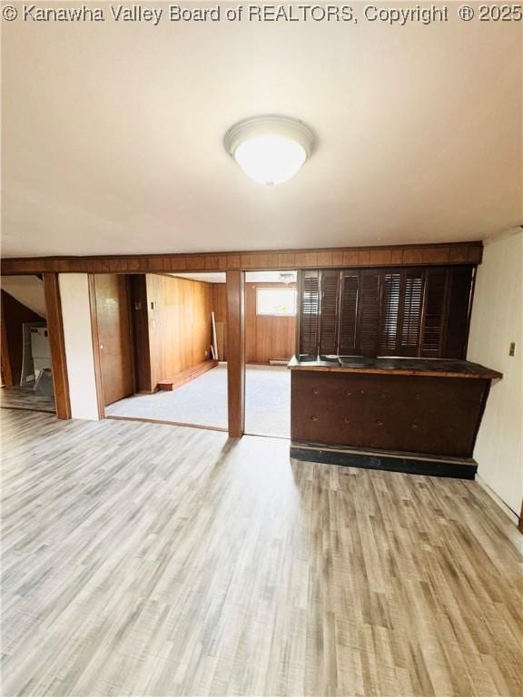 8612 Maryland Ave, Marmet, WV 25315 - unfurnished living room featuring wood finished floors and wood walls