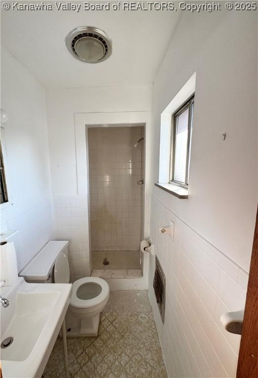 8612 Maryland Ave, Marmet, WV 25315 - full bath featuring tile walls, a shower stall, and a wainscoted wall