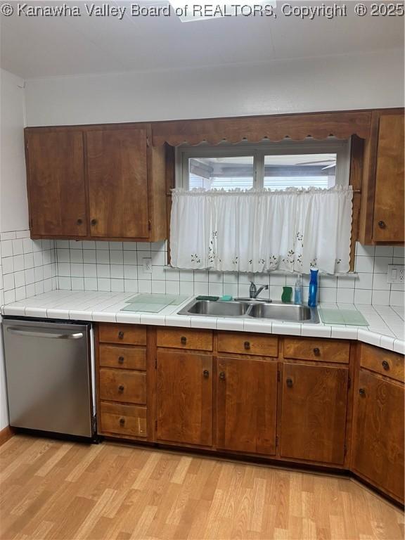 510 S Railway St, Cedar Grove, WV 25039 - kitchen featuring stainless steel dishwasher, light wood finished floors, backsplash, and brown cabinetry