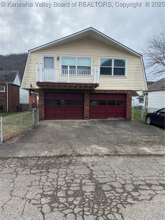 510 S Railway St, Cedar Grove, WV 25039 - dutch colonial with a gambrel roof, asphalt driveway, an attached garage, and brick siding