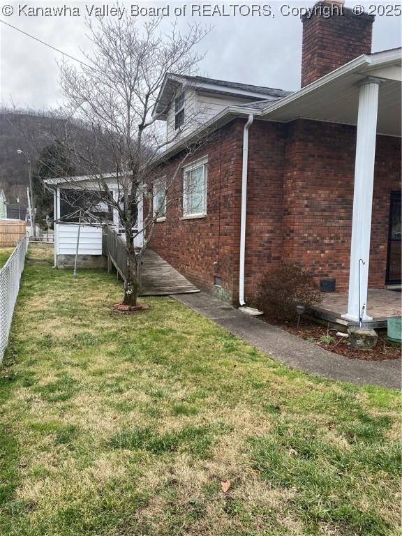 510 S Railway St, Cedar Grove, WV 25039 - view of side of property featuring brick siding, crawl space, and a chimney