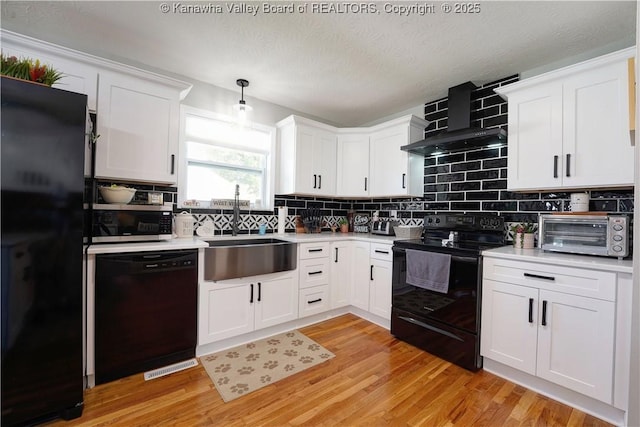 1204 Highland Dr, Saint Albans, WV 25177 - kitchen with black appliances, light countertops, white cabinets, and a textured ceiling