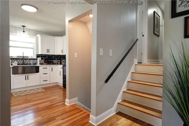 1204 Highland Dr, Saint Albans, WV 25177 - stairway featuring wood finished floors and a textured ceiling