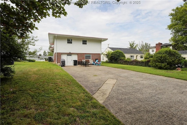 1204 Highland Dr, Saint Albans, WV 25177 - rear view of property featuring driveway, brick siding, and a yard