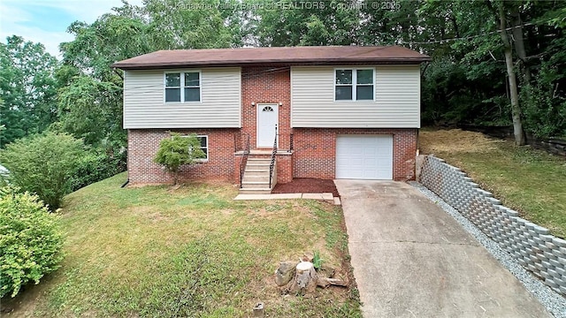 4013 Seymour Ln, Charleston, WV 25313 - split foyer home with brick siding, driveway, an attached garage, and a front lawn