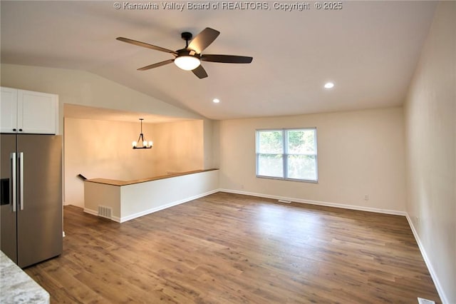 4013 Seymour Ln, Charleston, WV 25313 - unfurnished living room featuring a chandelier, lofted ceiling, wood finished floors, a ceiling fan, and recessed lighting