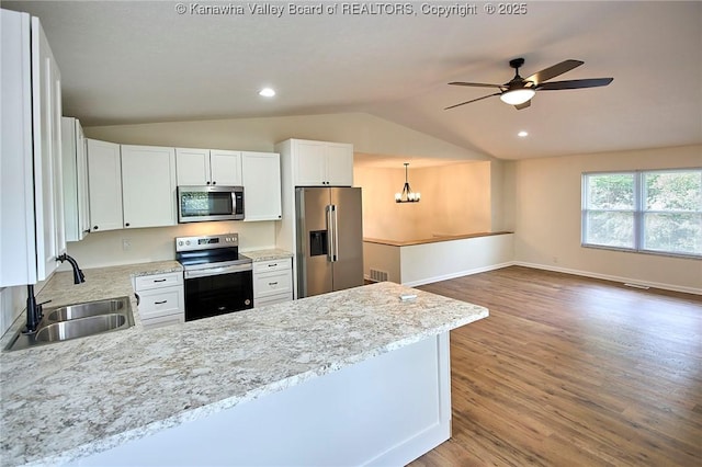 4013 Seymour Ln, Charleston, WV 25313 - kitchen with stainless steel appliances, lofted ceiling, a peninsula, wood finished floors, and ceiling fan