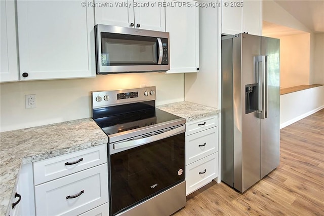 4013 Seymour Ln, Charleston, WV 25313 - kitchen with appliances with stainless steel finishes, light wood finished floors, and white cabinetry