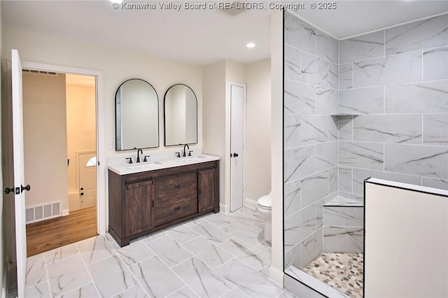 4013 Seymour Ln, Charleston, WV 25313 - bathroom with recessed lighting, marble look tiles, double vanity, and a tile shower