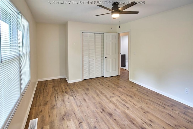 4013 Seymour Ln, Charleston, WV 25313 - unfurnished bedroom featuring a closet, wood finished floors, and a ceiling fan