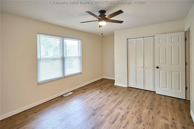 4013 Seymour Ln, Charleston, WV 25313 - unfurnished bedroom with wood finished floors, a closet, and ceiling fan