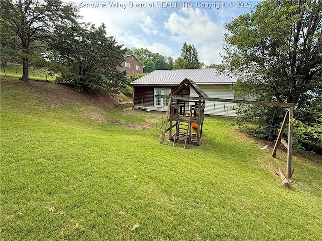 5005 Buffy Dr, Cross Lanes, WV 25313 - back of property with a yard, a metal roof, and a playground