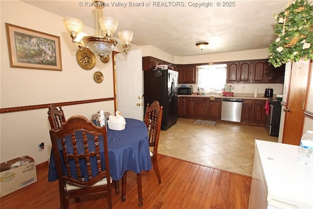 5005 Buffy Dr, Cross Lanes, WV 25313 - kitchen with stainless steel appliances, a chandelier, light countertops, and light wood-type flooring