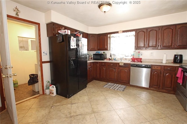 5005 Buffy Dr, Cross Lanes, WV 25313 - kitchen with black appliances, light countertops, and light tile patterned floors