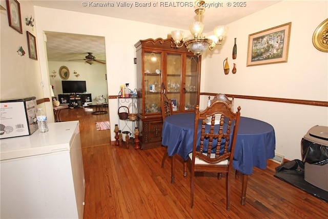 5005 Buffy Dr, Cross Lanes, WV 25313 - dining space with wood finished floors, a chandelier, and ceiling fan