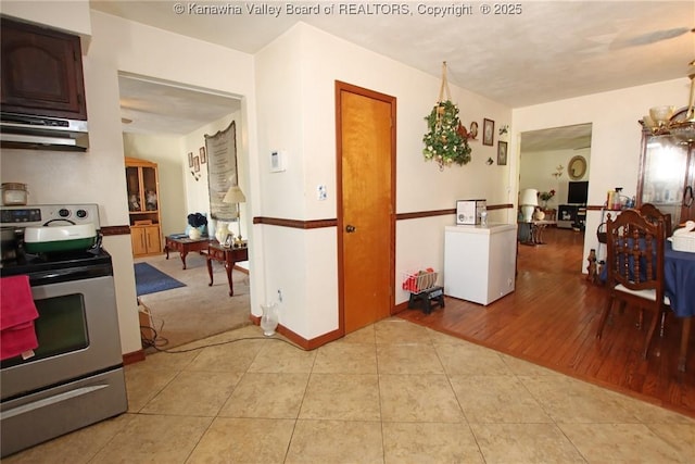 5005 Buffy Dr, Cross Lanes, WV 25313 - kitchen featuring stainless steel electric range oven, under cabinet range hood, and light tile patterned floors