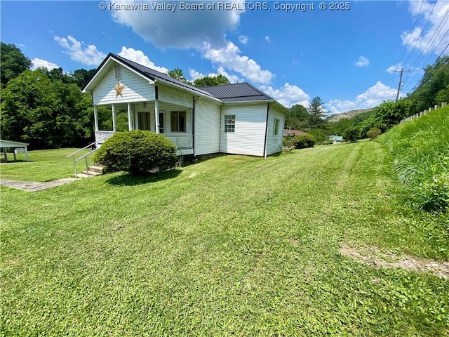 391 River Rd, Racine, WV 25165 - view of side of home featuring a lawn, a metal roof, and covered porch
