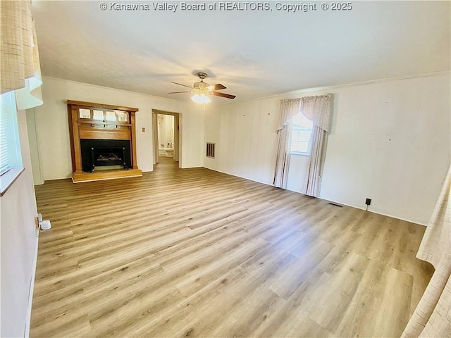 391 River Rd, Racine, WV 25165 - unfurnished living room featuring wood finished floors, ceiling fan, and a fireplace with raised hearth
