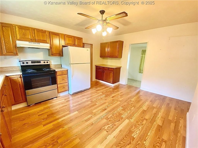 391 River Rd, Racine, WV 25165 - kitchen featuring stainless steel range with electric stovetop, under cabinet range hood, freestanding refrigerator, ceiling fan, and light wood-style flooring