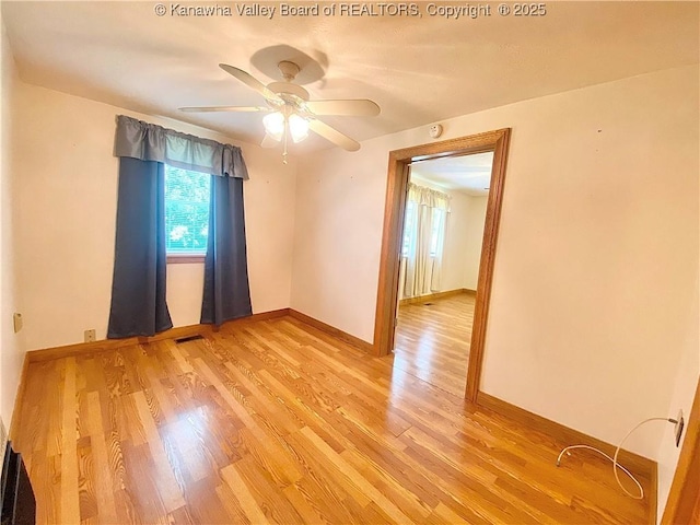 391 River Rd, Racine, WV 25165 - spare room with light wood-style flooring, a ceiling fan, and a smoke detector