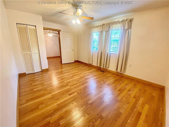 391 River Rd, Racine, WV 25165 - unfurnished bedroom with wood finished floors, a closet, and a ceiling fan