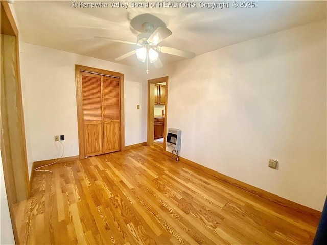 391 River Rd, Racine, WV 25165 - unfurnished bedroom with heating unit, light wood-style flooring, a closet, and ceiling fan