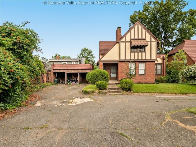 5 Manor Pl, Charleston, WV 25311 - tudor house with a chimney, brick siding, and a front lawn