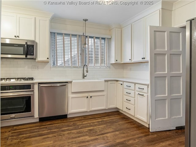 5 Manor Pl, Charleston, WV 25311 - kitchen featuring appliances with stainless steel finishes, light countertops, backsplash, crown molding, and white cabinets