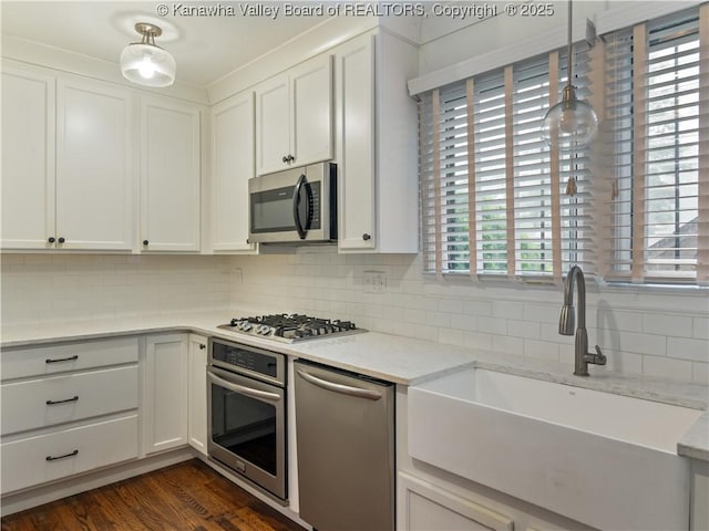 5 Manor Pl, Charleston, WV 25311 - kitchen with appliances with stainless steel finishes, backsplash, and white cabinetry