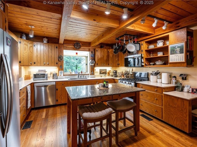 114 Shady Ln, Winfield, WV 25213 - kitchen featuring appliances with stainless steel finishes, track lighting, a wood ceiling with exposed beams, light wood-style floors, and brown cabinets