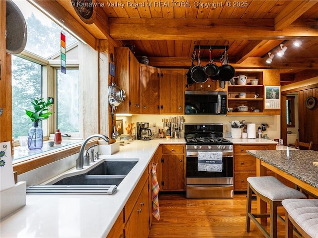 114 Shady Ln, Winfield, WV 25213 - kitchen featuring stainless steel appliances, a wood ceiling with exposed beams, light wood-type flooring, brown cabinets, and light countertops