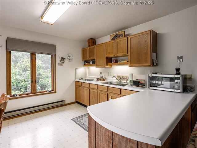 114 Shady Ln, Winfield, WV 25213 - kitchen with stainless steel microwave, baseboard heating, open shelves, a peninsula, and light countertops