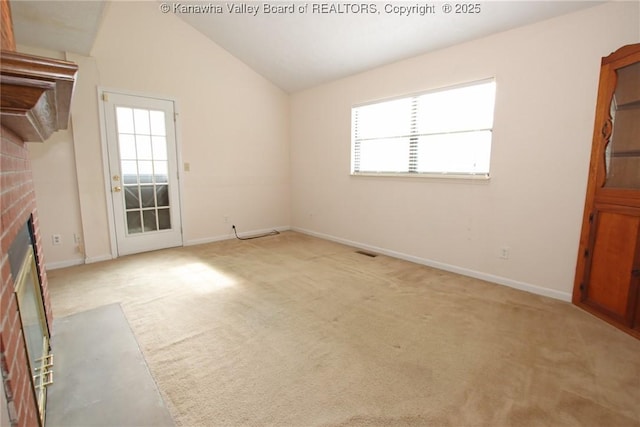1302 Hunters Ridge Rd, Charleston, WV 25314 - unfurnished living room featuring a fireplace, carpet flooring, and vaulted ceiling