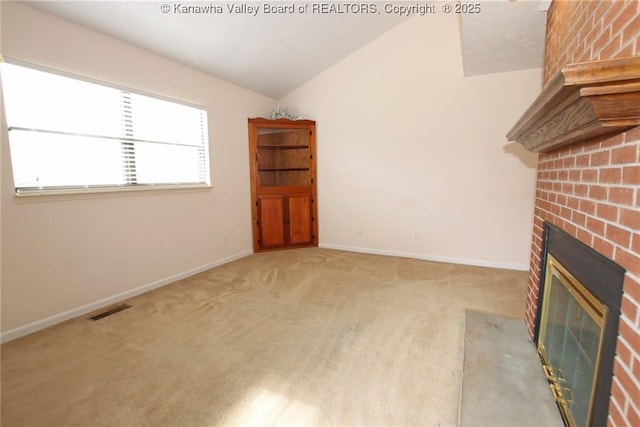 1302 Hunters Ridge Rd, Charleston, WV 25314 - unfurnished living room featuring a brick fireplace, vaulted ceiling, and light carpet