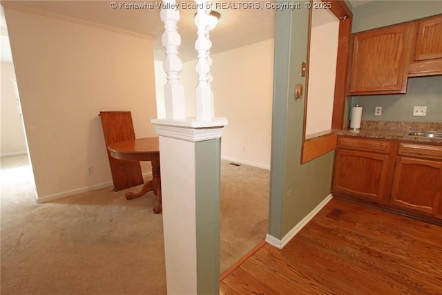 1302 Hunters Ridge Rd, Charleston, WV 25314 - kitchen featuring light colored carpet and brown cabinetry