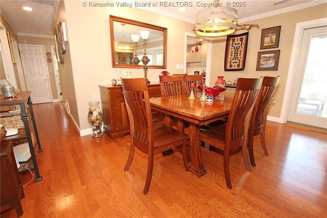 1500 Longridge Rd, Charleston, WV 25314 - dining space featuring wood finished floors, crown molding, recessed lighting, and a chandelier