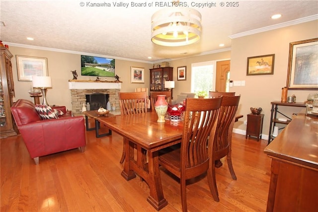 1500 Longridge Rd, Charleston, WV 25314 - dining room featuring light wood-type flooring, recessed lighting, a stone fireplace, a textured ceiling, and ornamental molding