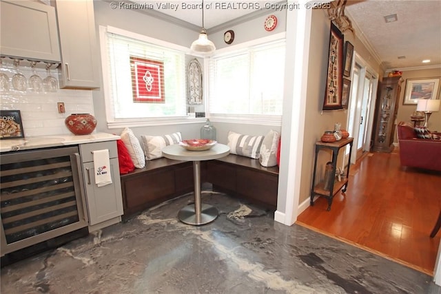 1500 Longridge Rd, Charleston, WV 25314 - indoor dry bar with ornamental molding, wine cooler, tasteful backsplash, and decorative light fixtures