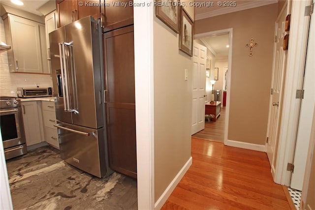 1500 Longridge Rd, Charleston, WV 25314 - kitchen with stainless steel appliances, ornamental molding, backsplash, wood finished floors, and light countertops