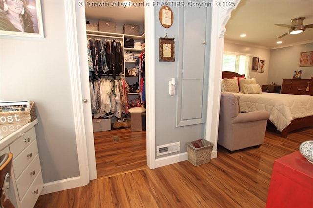 1500 Longridge Rd, Charleston, WV 25314 - bedroom with wood finished floors, ornamental molding, and a walk in closet