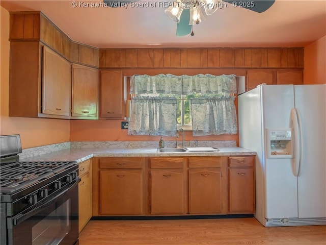 567 Garrison Ave, Charleston, WV 25302 - kitchen featuring white fridge with ice dispenser, black gas stove, light countertops, light wood finished floors, and a ceiling fan