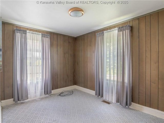 567 Garrison Ave, Charleston, WV 25302 - carpeted empty room featuring healthy amount of natural light and wood walls