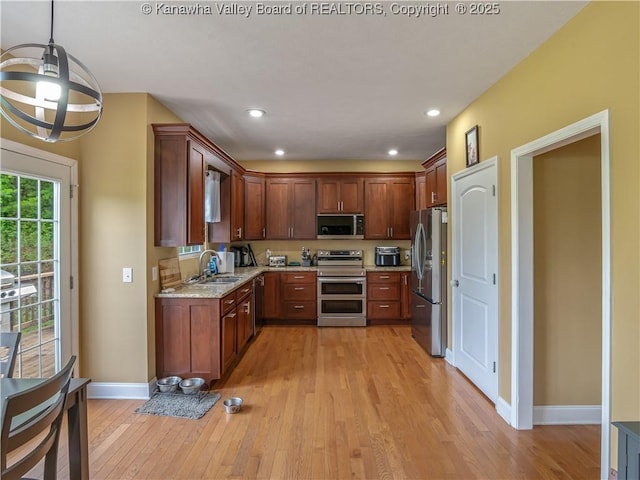 35 Hyde Park Rd, Winfield, WV 25213 - kitchen with appliances with stainless steel finishes, light wood-style floors, light stone counters, recessed lighting, and pendant lighting