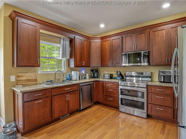 35 Hyde Park Rd, Winfield, WV 25213 - kitchen with stainless steel appliances, light wood-type flooring, light stone counters, and recessed lighting
