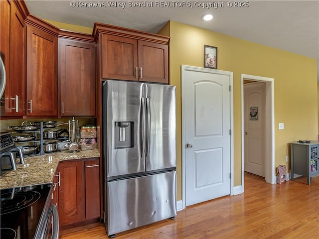35 Hyde Park Rd, Winfield, WV 25213 - kitchen featuring stainless steel fridge, light stone counters, light wood-type flooring, recessed lighting, and brown cabinets