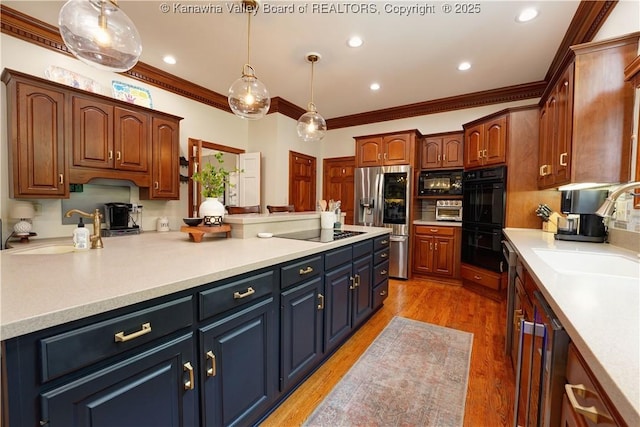 135 E Ridge Rd, Charleston, WV 25314 - kitchen with black appliances, ornamental molding, light countertops, light wood-style flooring, and recessed lighting