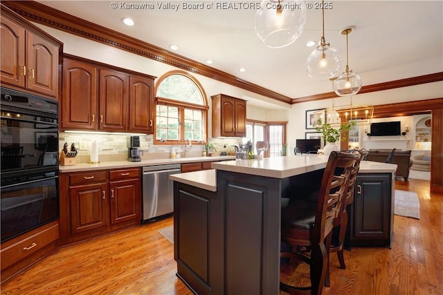 135 E Ridge Rd, Charleston, WV 25314 - kitchen with dishwasher, light countertops, a kitchen island, backsplash, and a kitchen breakfast bar